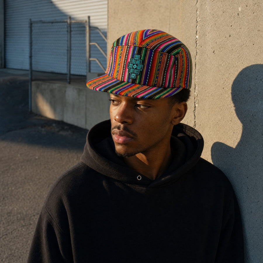 A man wearing the handwoven Andean camp cap on a sunlit downtown street