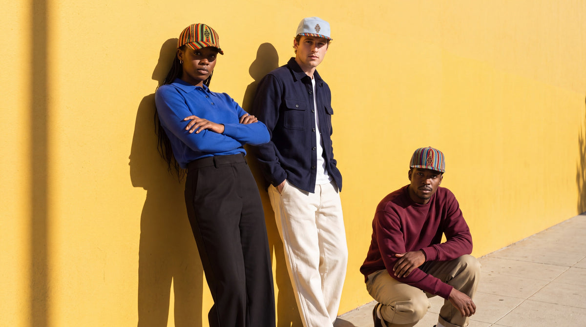 Street — three friends against a sunlit yellow wall downtown